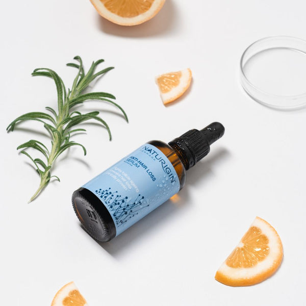 NATURIGIN Anti-Hair Loss Serum with rosemary and lemon, promoting thicker, healthier hair.