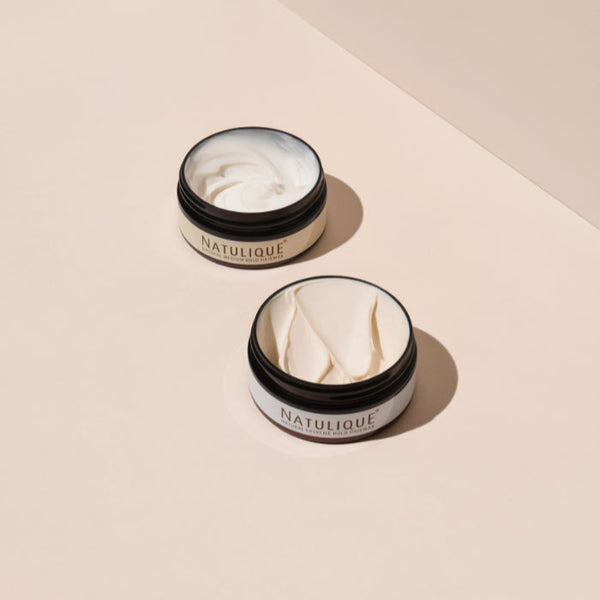 NATULIQUE Organic Medium Hold Hair Wax jars with creamy textures on a beige background, sustainable professional quality.