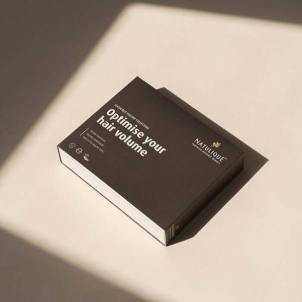 NATULIQUE ORGANIC VOLUME GIFT SET packaging, featuring 'Optimise Your Hair Volume' on a sleek black box.
