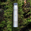 NATULIQUE Anti-Pollutive Dry Shampoo on moss background, featuring clean beauty for detoxing hair.