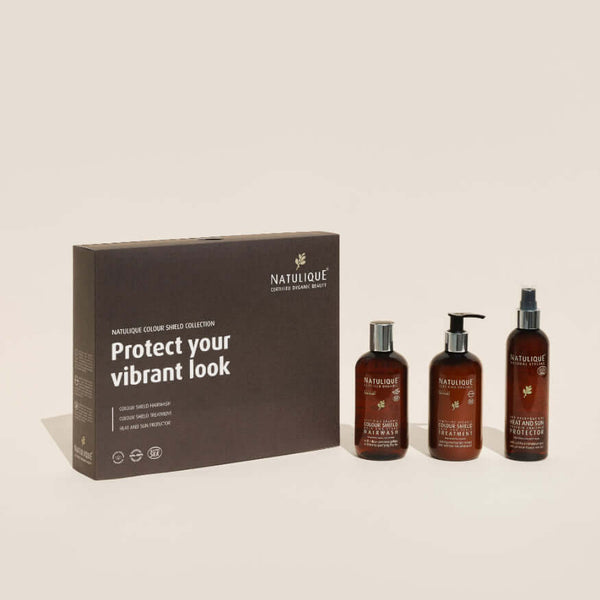 NATULIQUE Colour Shield Gift Set featuring three bottles for vibrant color care and protection for treated hair.