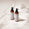 NATULIQUE Curls & Waves Shampoo and Conditioner bottles on a soft background for hydration and definition.