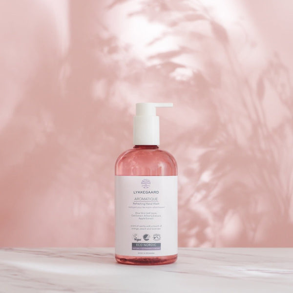 LYKKEGAARD Aromatique Refreshing Hand Wash bottle with gentle pink background, highlighting nature-inspired wellness.
