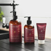 NATULIQUE organic protective handwash, moisturizing hand sanitizer, and hand cream on a kitchen counter.