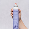 NATURIGIN Medium Hold Finishing Hairspray in hand, designed for flexible hold and organic nourishment for healthy hair.