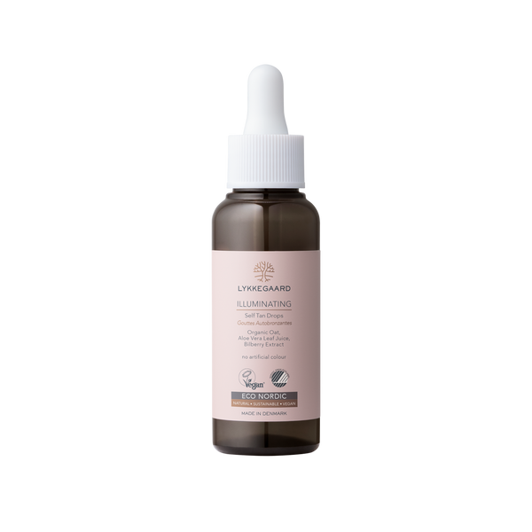 LYKKEGAARD Illuminating Self Tan Drops bottle, organic vegan formula for a natural sun-kissed glow without sun damage.