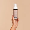 LYKKEGAARD Illuminating Exclusive Self Tan Foam held in hand against a light background for a radiant glow.